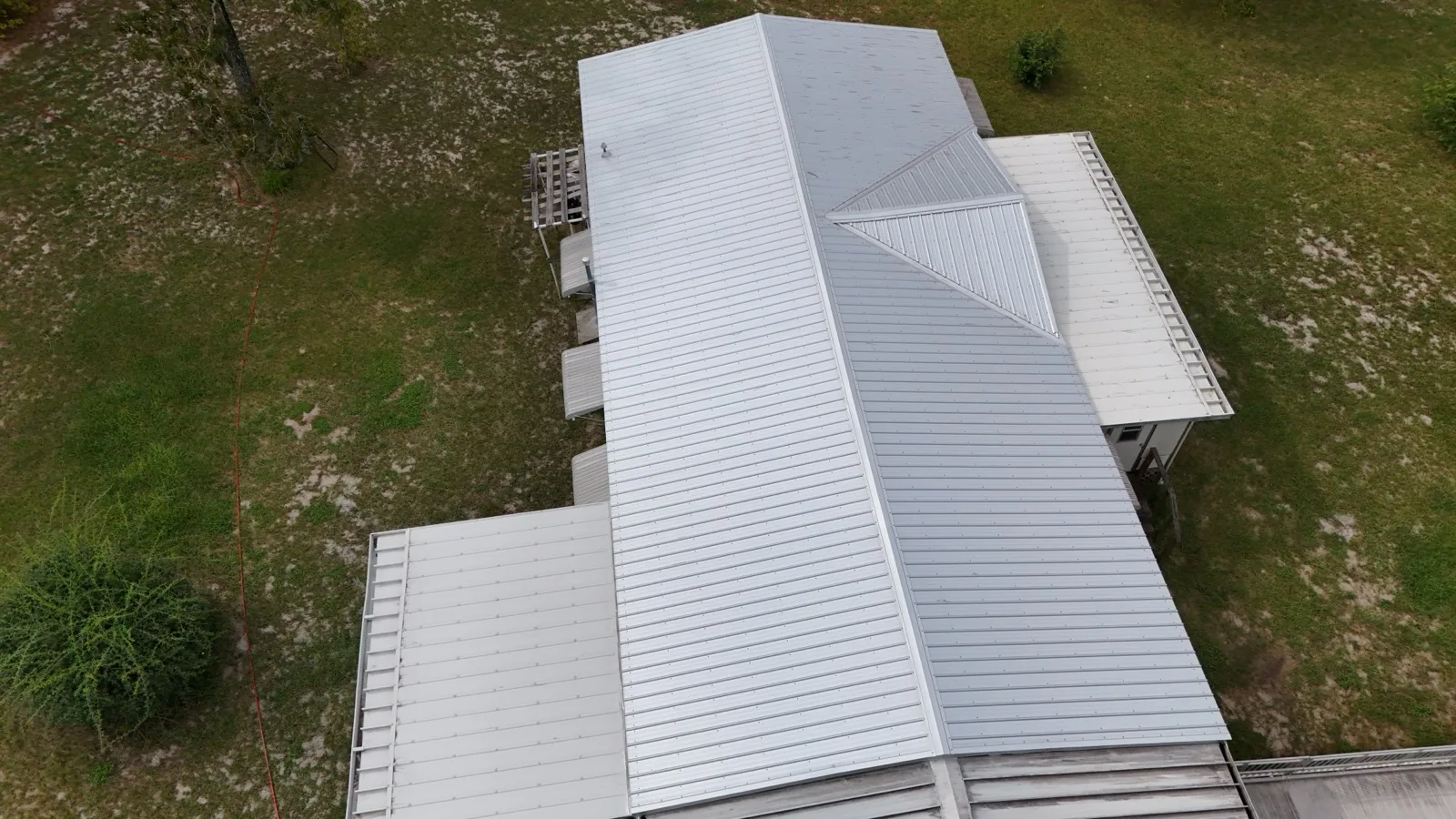Overhead view of standing-seam metal roof panels and ridge on a Central Florida home