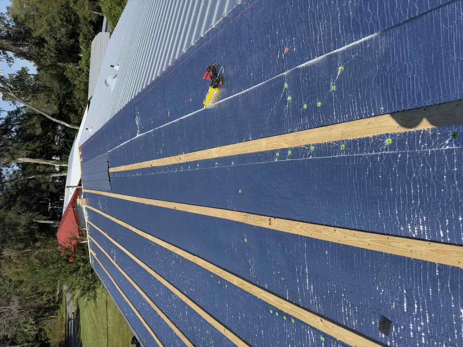 Metal roof panel going down over purlins and radiant insulation in Central Florida